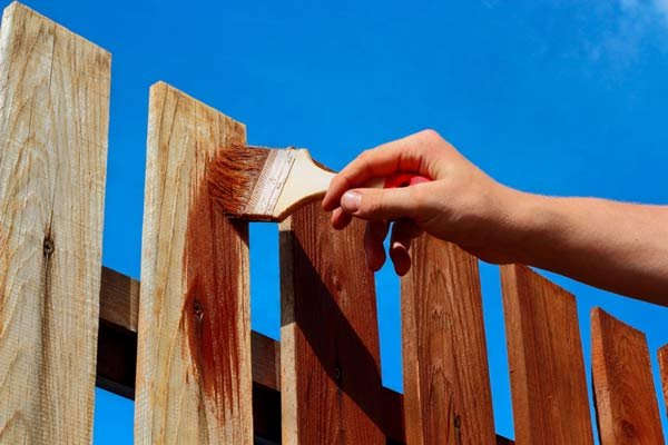 Professionally sealed wooden fence with natural finish and protected exterior boards